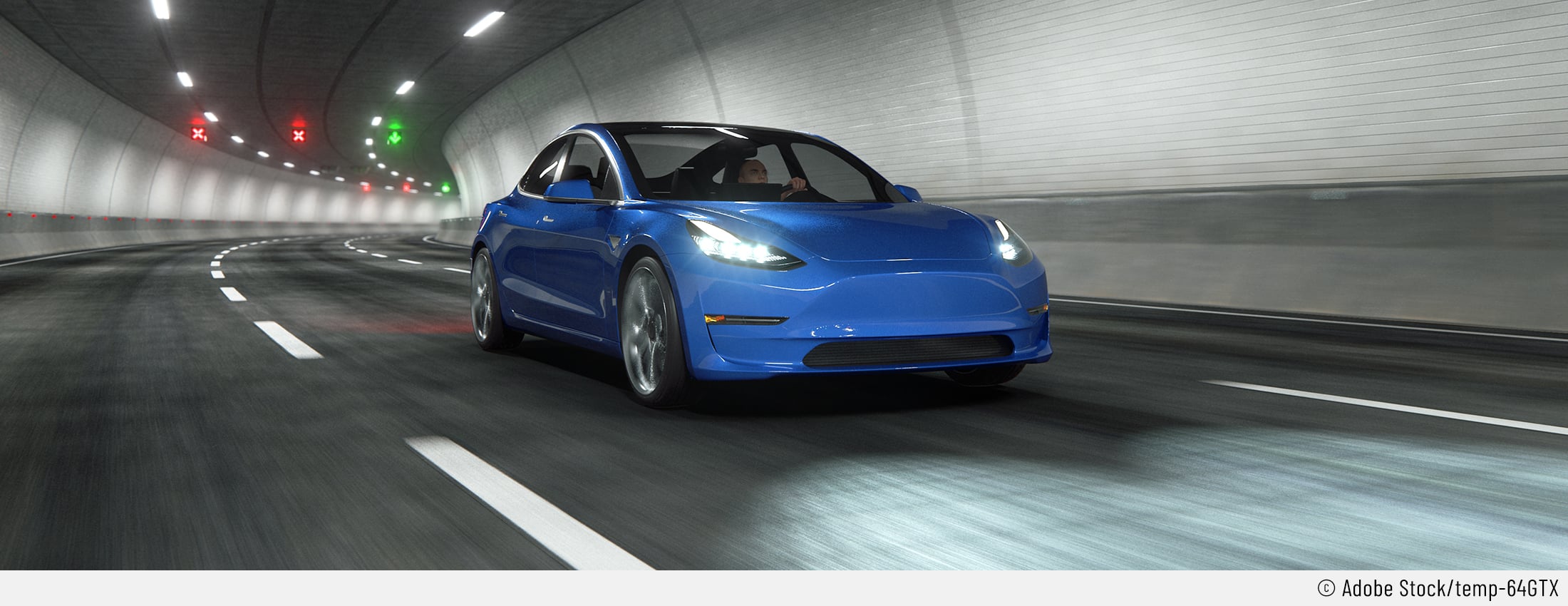 Auf dem Bild ist ein blaues Auto zu sehen, dessen Markenlogo nicht zu sehen ist. Es fährt sehr schnell durch einen Tunnel und es sieht nach einem Tesla ausser Kontrolle aus.